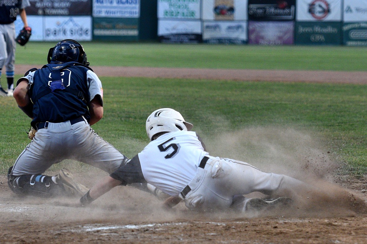 Glacier Twins&#146; Nathan Hader slides home for the game-ending run against the Gonzaga Prep Bullpups in their opening game in the Sapa-Johnsrud Memorial Baseball Tournament on Thursday. (Aaric Bryan/Daily Inter Lake)