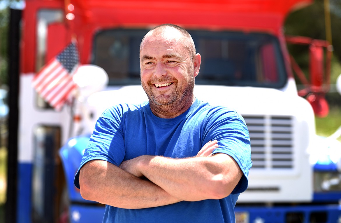 Jeff Messick with the red, white and blue bus he has been working on for five years, on June 19, in Evergreen.
(Brenda Ahearn/Daily Inter Lake)
