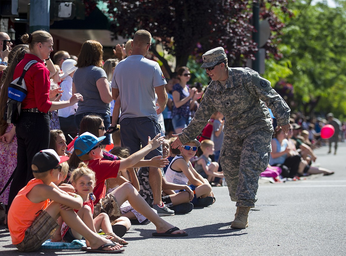 LOREN BENOIT/PressU.S. Army Specialist Brittany Wright gives high-fives down the parade route.