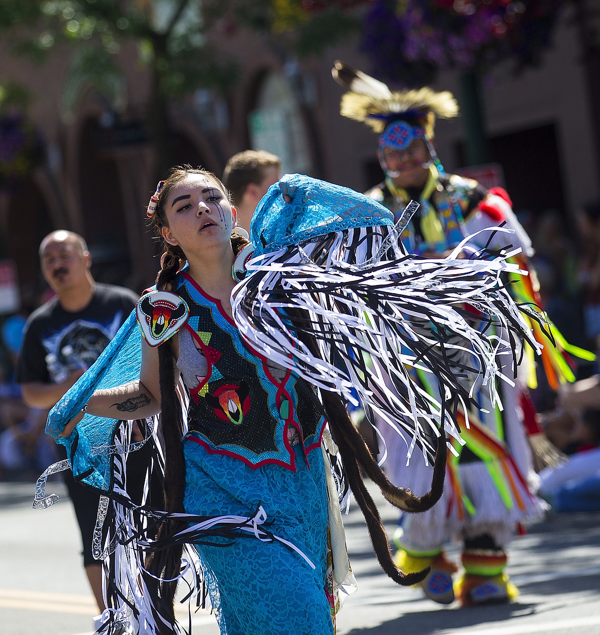 LOREN BENOIT/PressSierra Haynes of the Coeur d'Alene Tribe dances down the July Fourth parade route in traditional regalia.