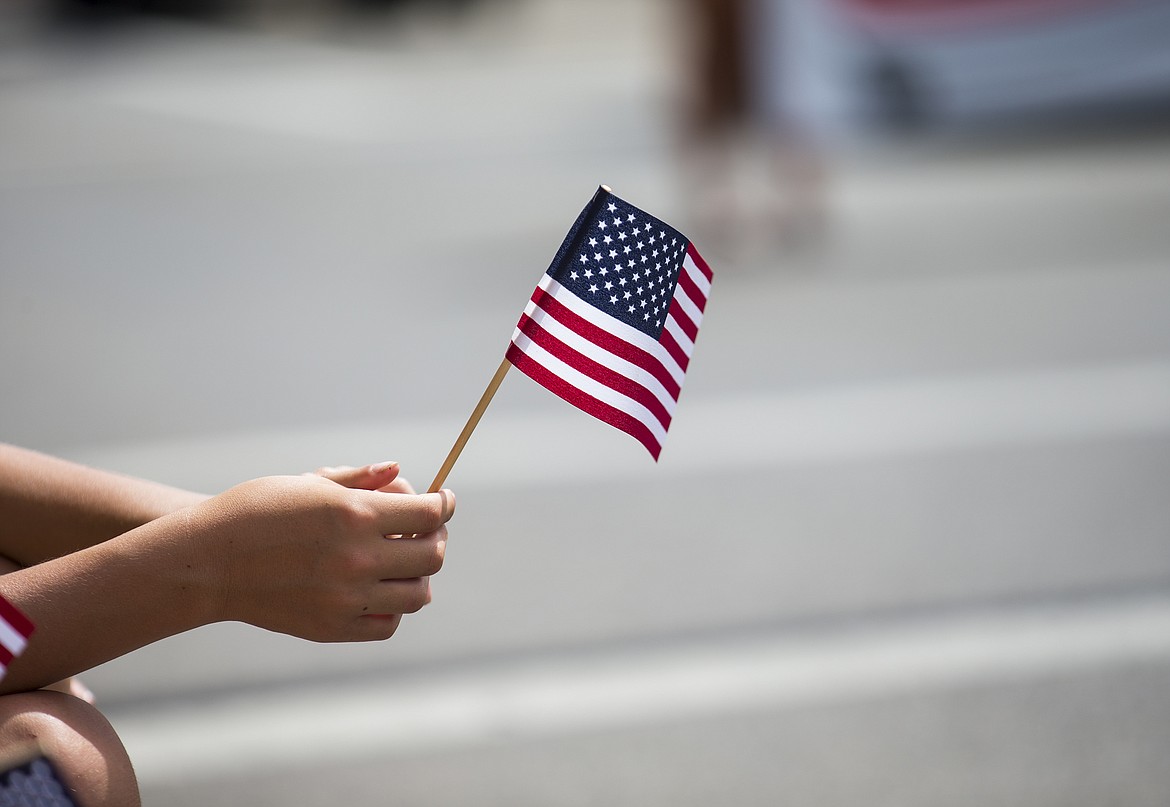 LOREN BENOIT/PressA spectator waves an American Flag during the 2017 July Fourth Hometown Heroes Parade.