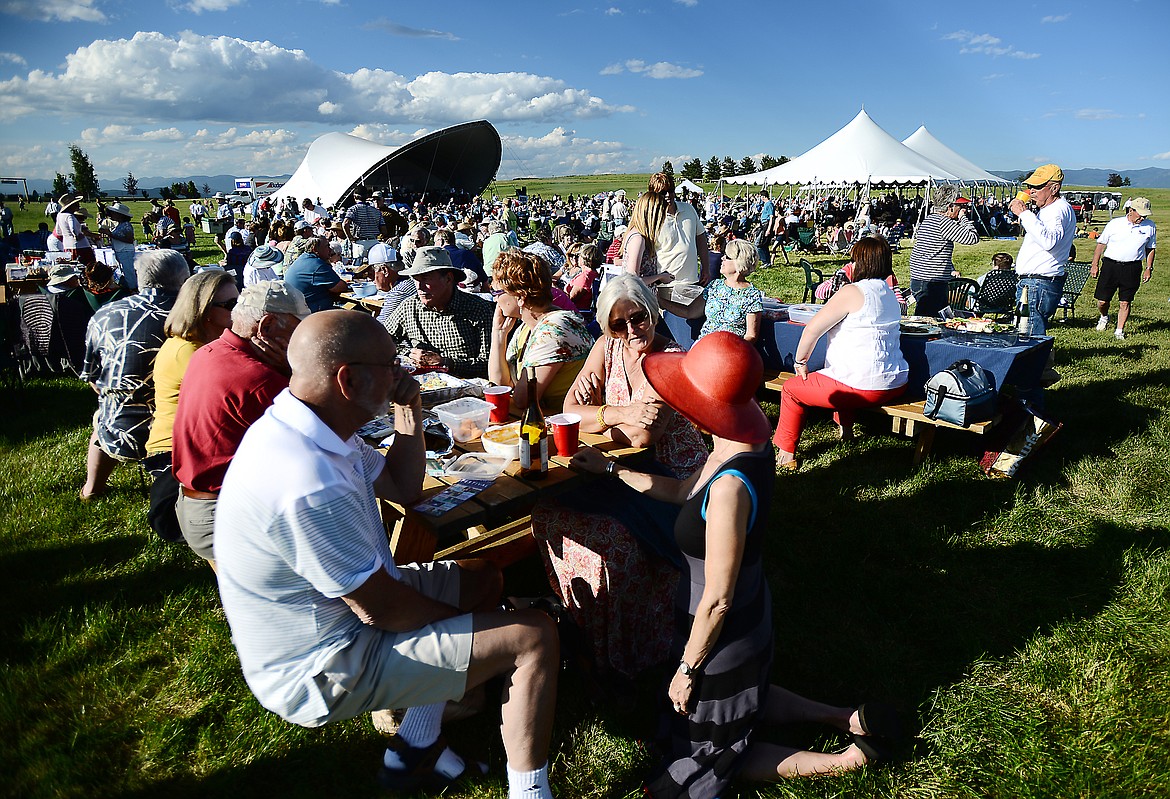 CONCERTGOERS CHAT at a 2016 summer pops series concert with the symphony&#146;s custom shell in the background.