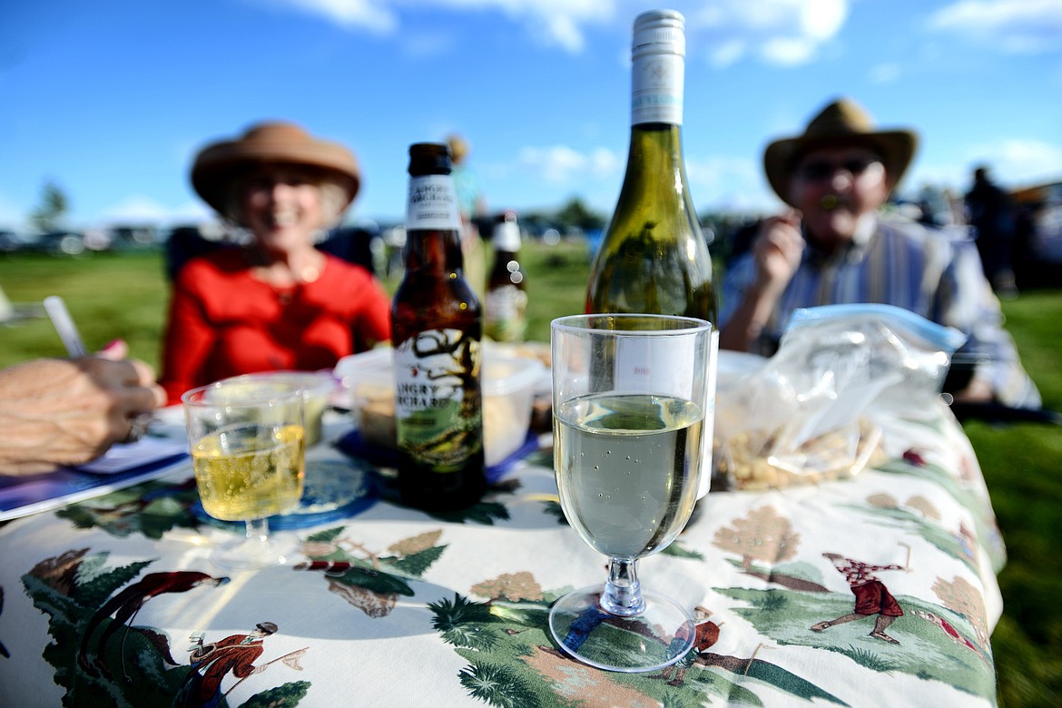 GUESTS ENJOY a picnic at a summer pops concert.