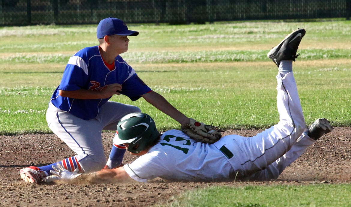 Rodney Harwood/Columbia Basin HeraldMoses Lake Walleyes runner Radley Greer (13) gets in under the tag of Yakima's Geoff Edgar during the first game of Thursdeay's doubleheader at Larson Playfield. The Walleyes won the opener in estra innings.
