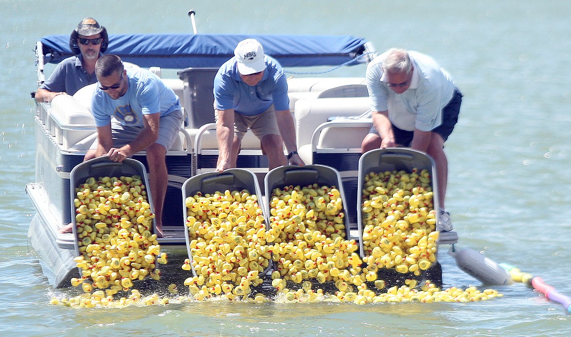 Rodney Harwood/Columbia Basin Herald
Volunteers dump the ducks into the water at Cascade Park Saturday as part of last year&#146;s Duck Derby.