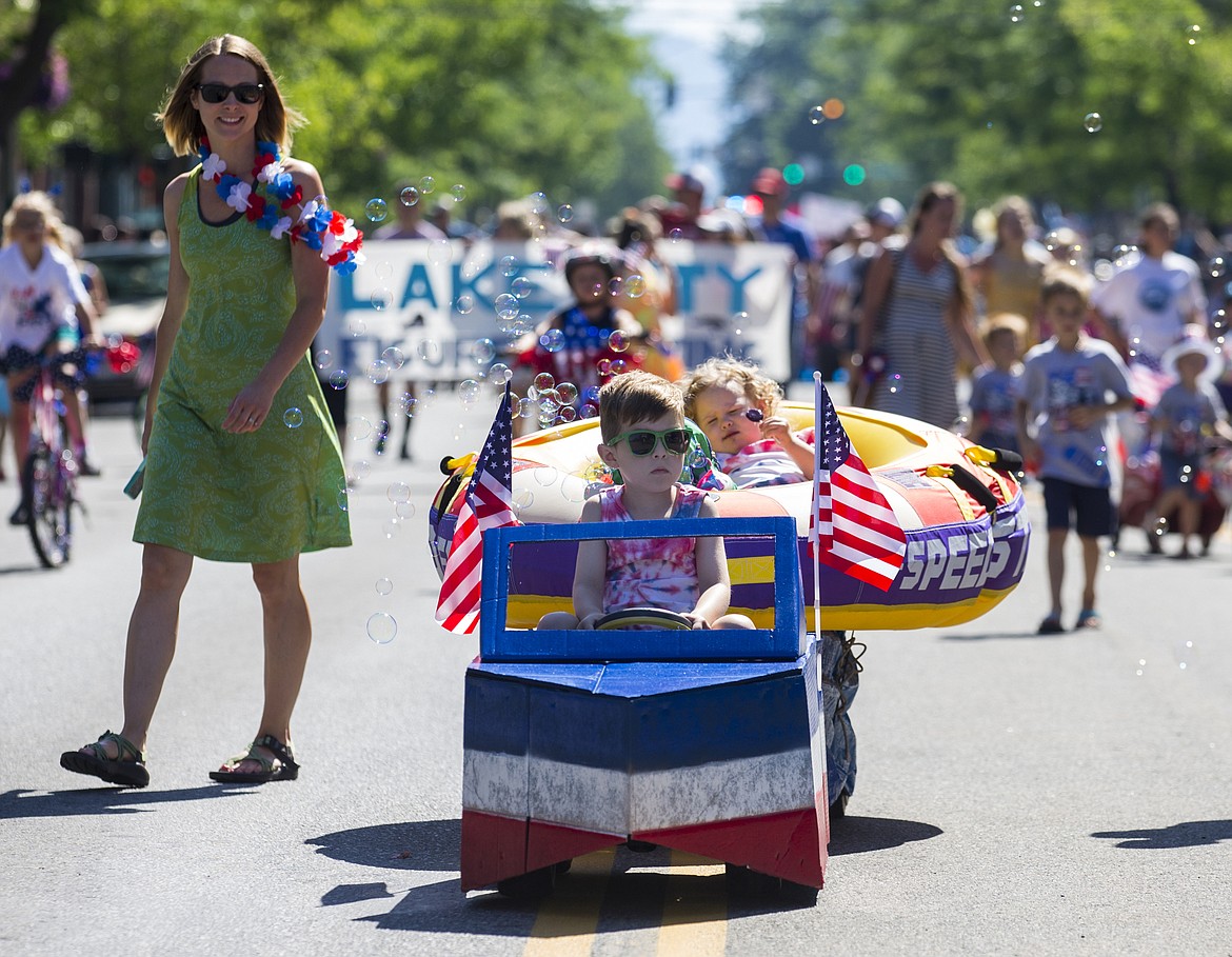 LOREN BENOIT/PressLiam Fields, 5, drives his sister, Kit, 2, down Sherman Avenue during July Kiddie Parade on Monday.  This year's theme was &#147;Coeur D&#146;Alene- What makes it special.&#148;