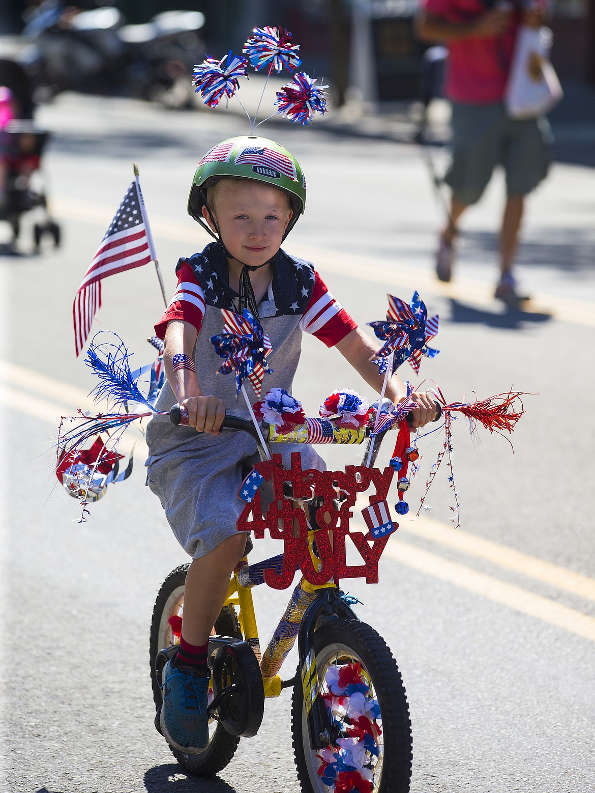 LOREN BENOIT/PressTate Merry, 6, rides down Sherman Avenue during the July Kiddies Parade Monday morning.