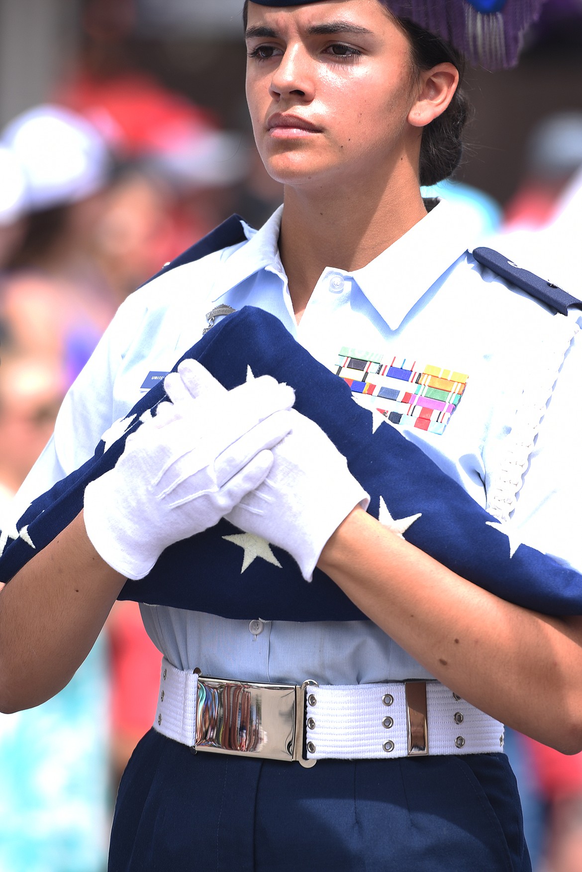 A Civil Air Patrol cadet carries a folded American Flag at the introduction to the Bigfork Fourth of July Parade on Tuesday afternoon, July 4. (Brenda Ahearn/Daily Inter Lake)