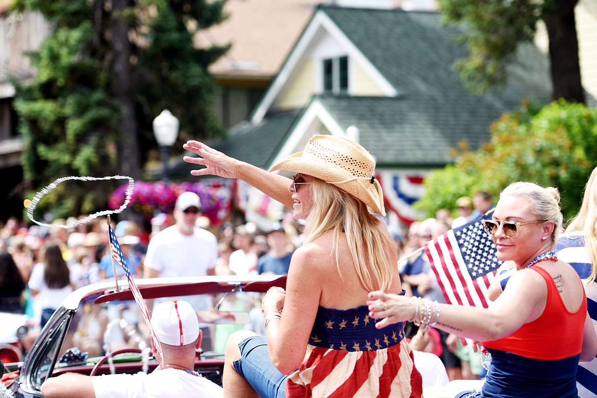 Throwing beads at the Bigfork Fourth of July Parade on Tuesday afternoon, July 4. (Brenda Ahearn/Daily Inter Lake)