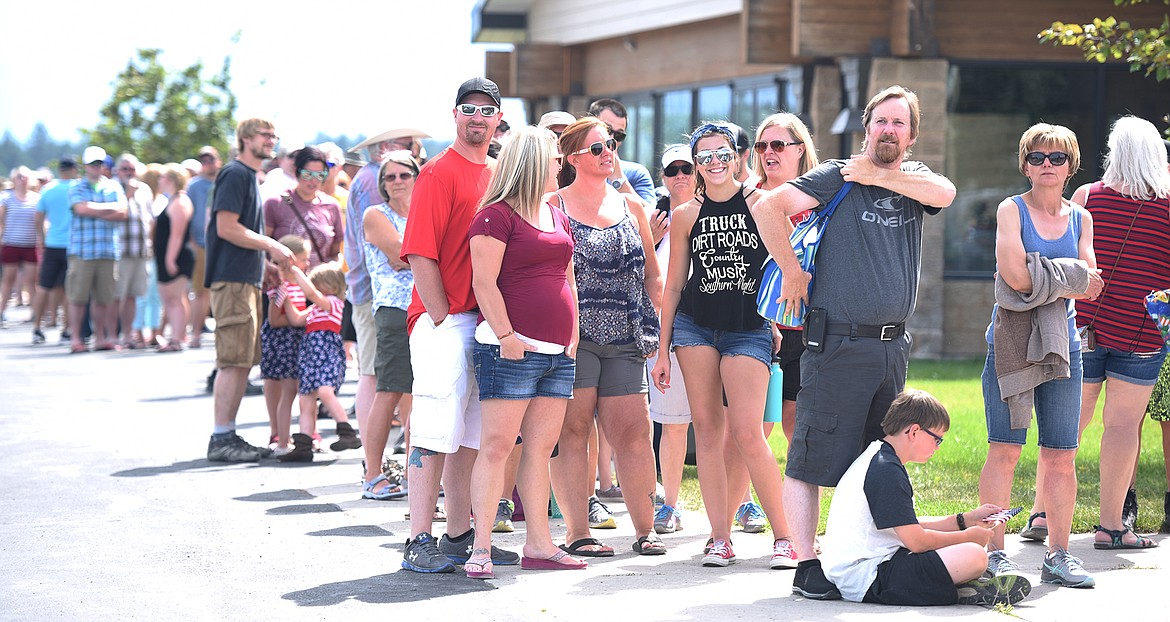 Crowds waiting for the shuttle at Crossroads Christian Church in Bigfork before the Bigfork Fourth of July Parade on Tuesday afternoon, July 4. (Brenda Ahearn/Daily Inter Lake)