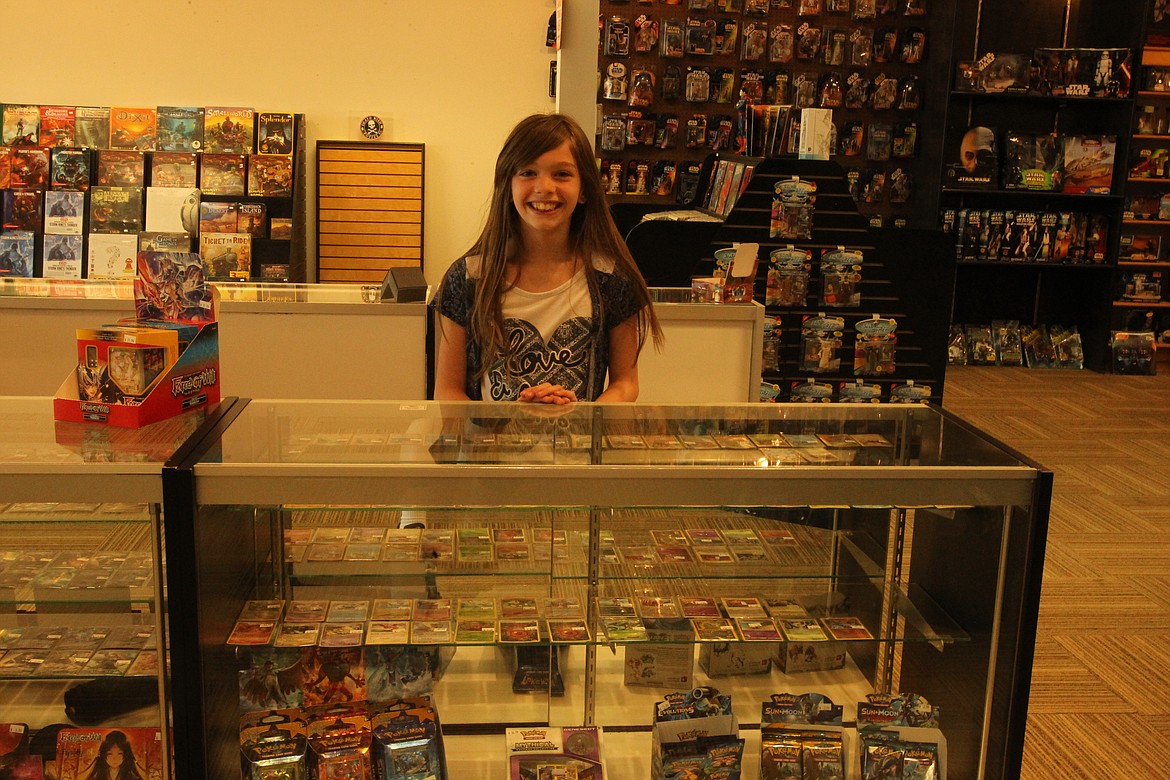 MITCHELL BONDS/Press
Katrina Knight, 10, stands behind a display of Pok&eacute;mon trading cards Sunday afternoon, her favorite thing at Knowhere Comics, Coffee and Games in Post Falls.