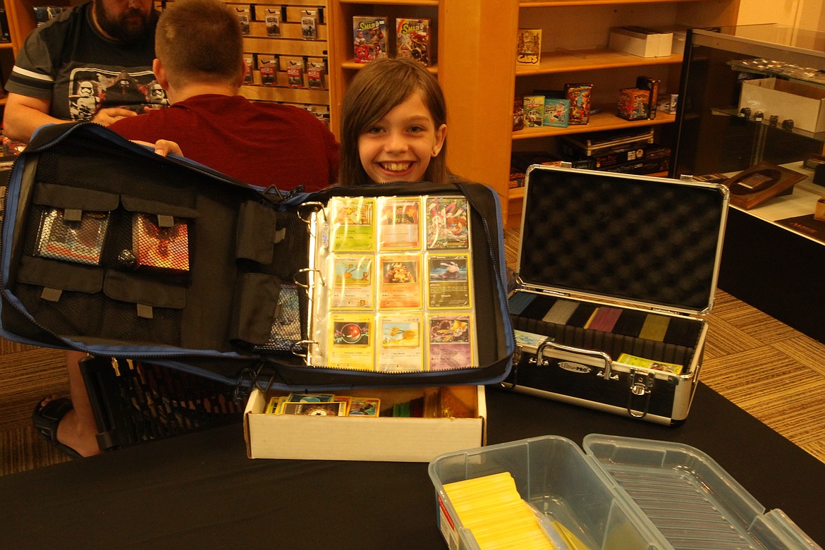 Mitchell Bonds/Press
Katrina Knight, 10, shows off her Pok&eacute;mon trading card collection Sunday at Knowhere Comics, Coffee and Games in Post Falls.