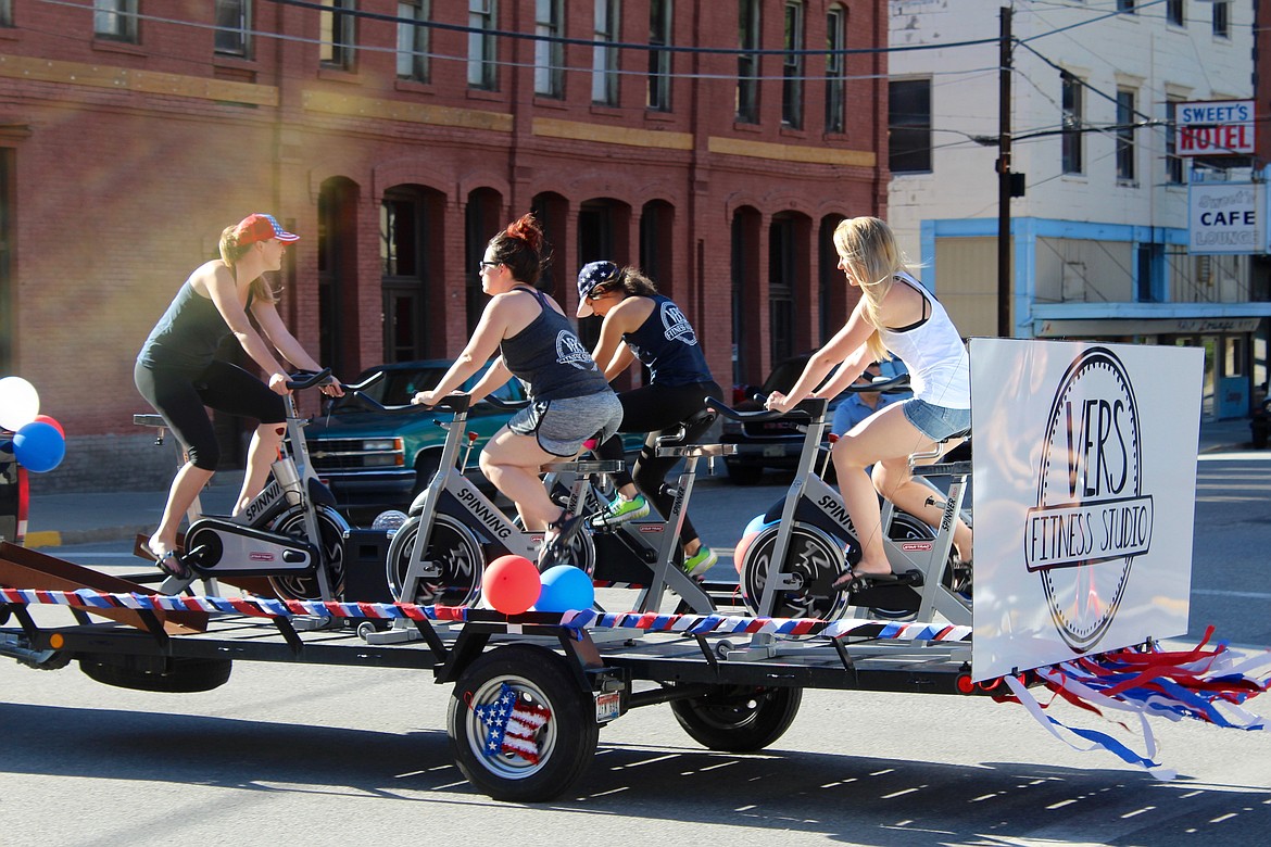 Spinners from VERS Fitness Studio break a sweat on their float in the parade.