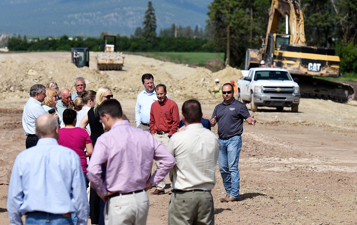 Jeff Claridge, the vice president of LHC, gives a tour of the North Kalispell Town Center development on Tuesday. Top, work is in progress to construct the Ford dealership at the Kalispell North Town Center (Aaric Bryan photos/Daily Inter Lake)
