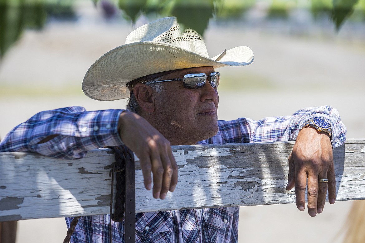 LOREN BENOIT/PressWayne Cordeiro watches riders compete in the Idaho State Mounted Shoot Out Friday afternoon at the Kootenai County Fairgrounds.