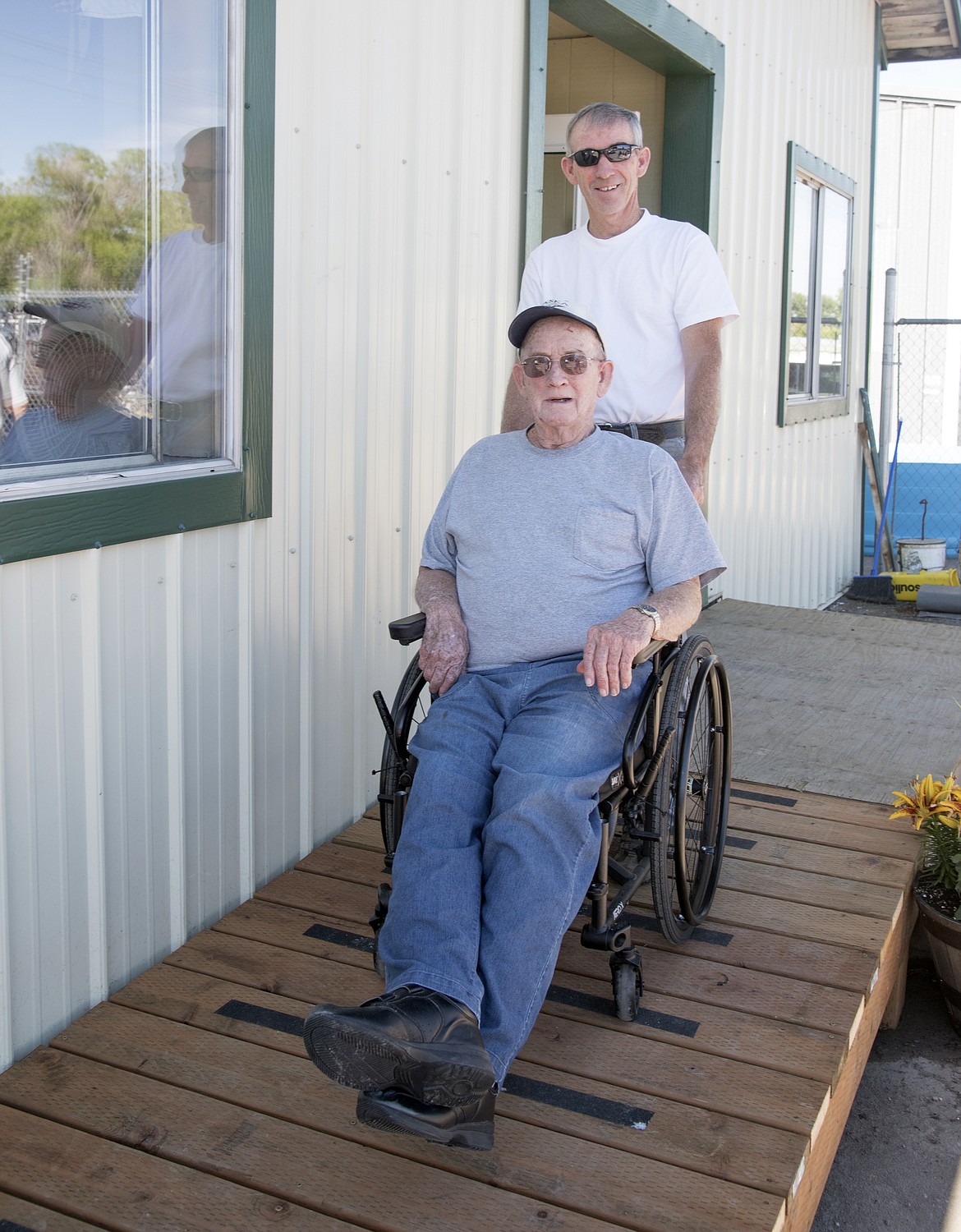 Jim anderson wheels his father, Paul, down the new ramp constructed at the Ronan VFW. (Marla Hall/Lake County Leader)