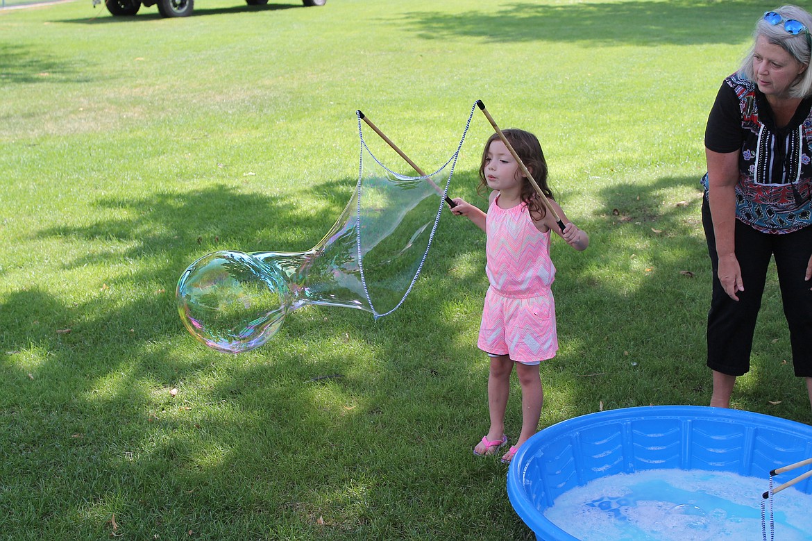 Charles H. Featherstone/Columbia Basin Herald
A girl makes a giant bubble in McCosh Park park during Freedom Fest on Saturday.?