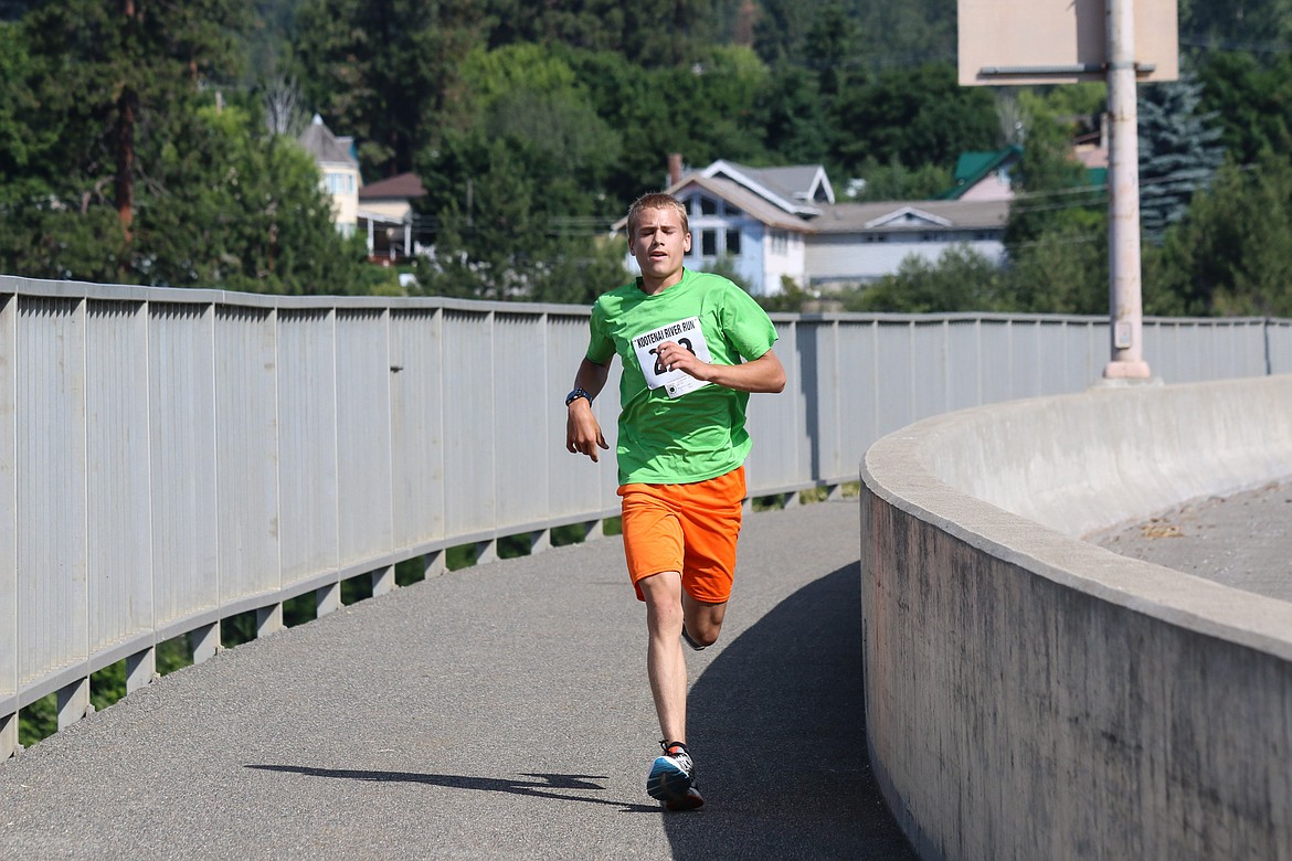 Photo by Mandi Bateman
Matthais Merrill, Winner of the Men&#146;s 5K, is first to cross back over the bridge.