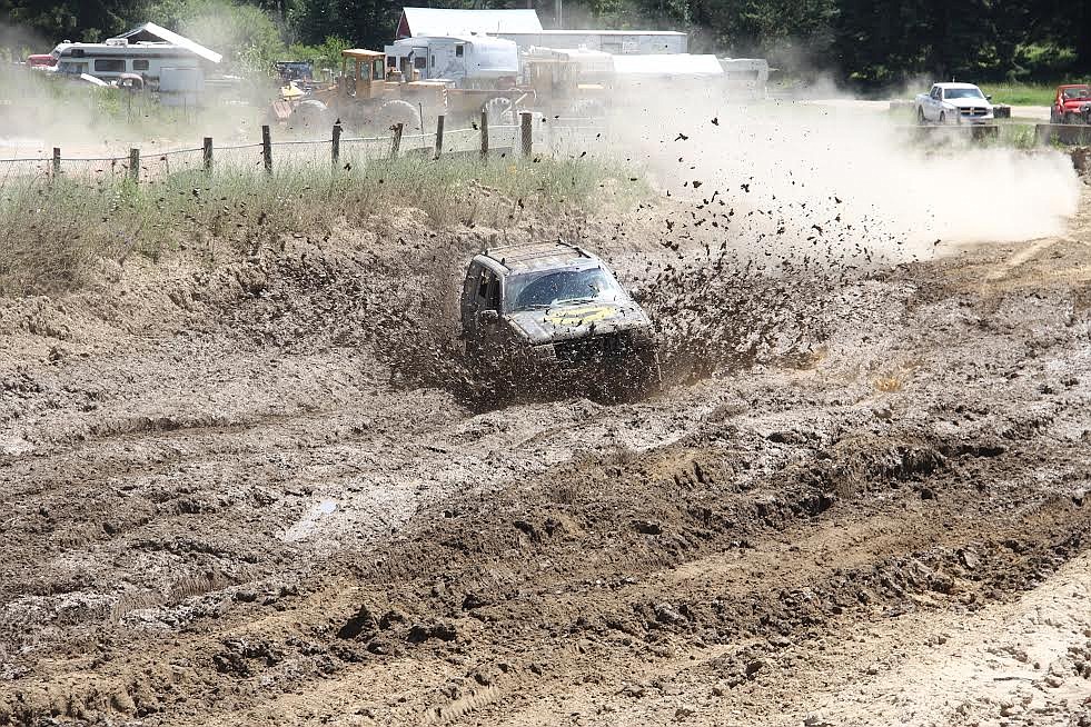 Photo by Tanna Larsen
... while this photo was taken at ground level as Lummus makes the mud fly in her &#145;Batmobile.&#146;