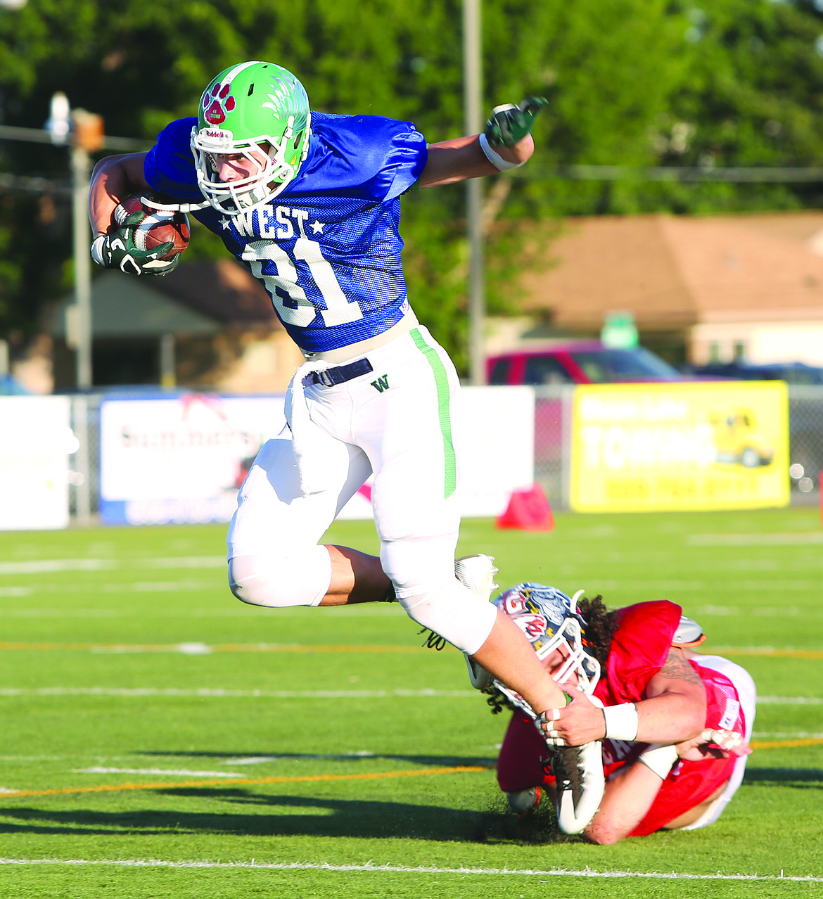 Connor Vanderweyst/Columbia Basin Herald
Woodinville's Michael Roth is brought down by the ankles during the East vs. West All-State football game.