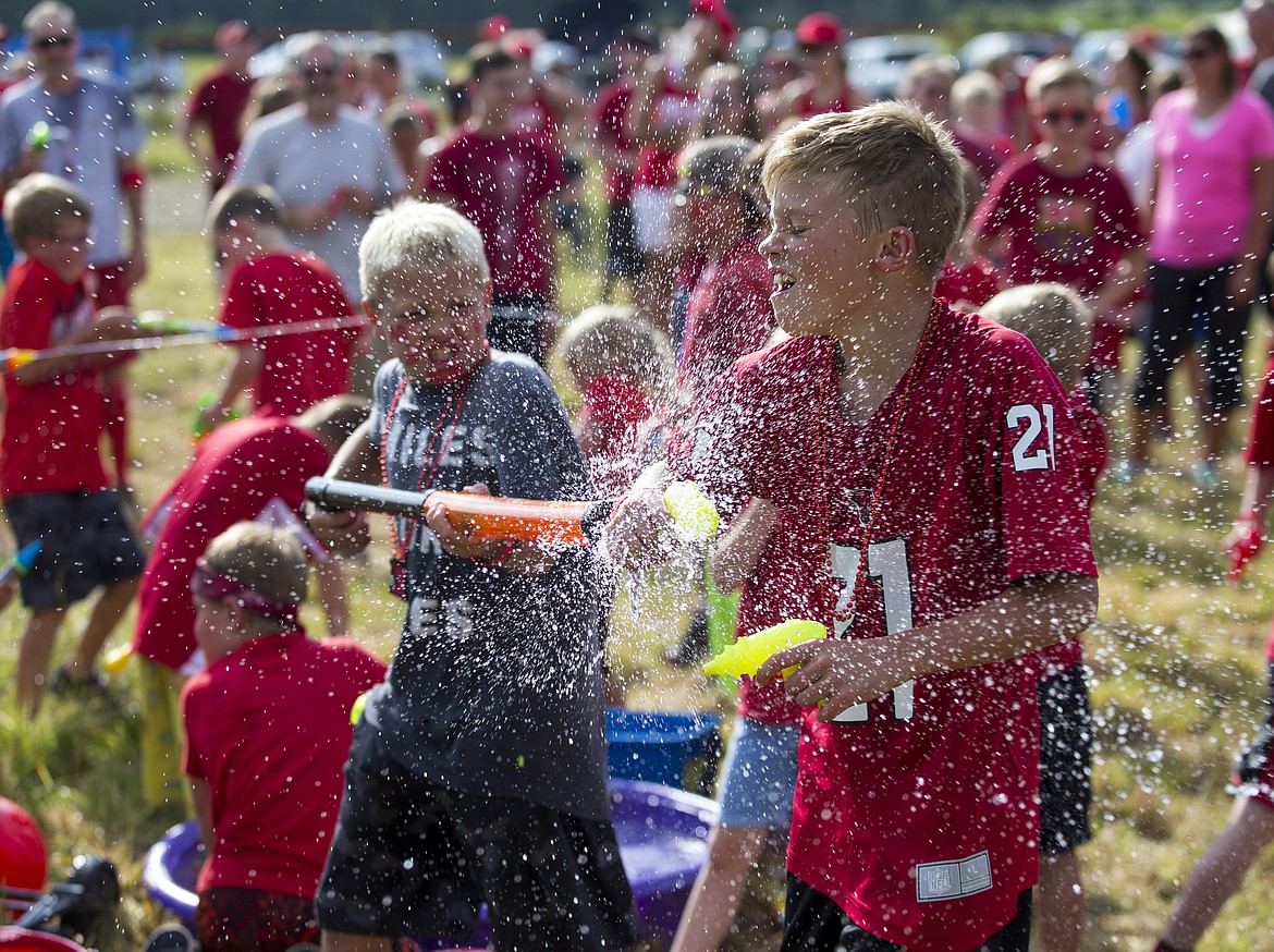 LOREN BENOIT/PressGabe Larsen drenches his friend Skylar Peterson with water prior to the Smiles for Miles Fun Run on Saturday in Hayden.