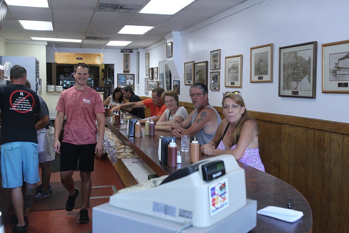 MITCHELL BONDS/Press
Dawson Williams, left, gets ready to take burger orders from the first half-dozen people in the door as soon as Hudson&#146;s Hamburgers opened on Sunday morning.