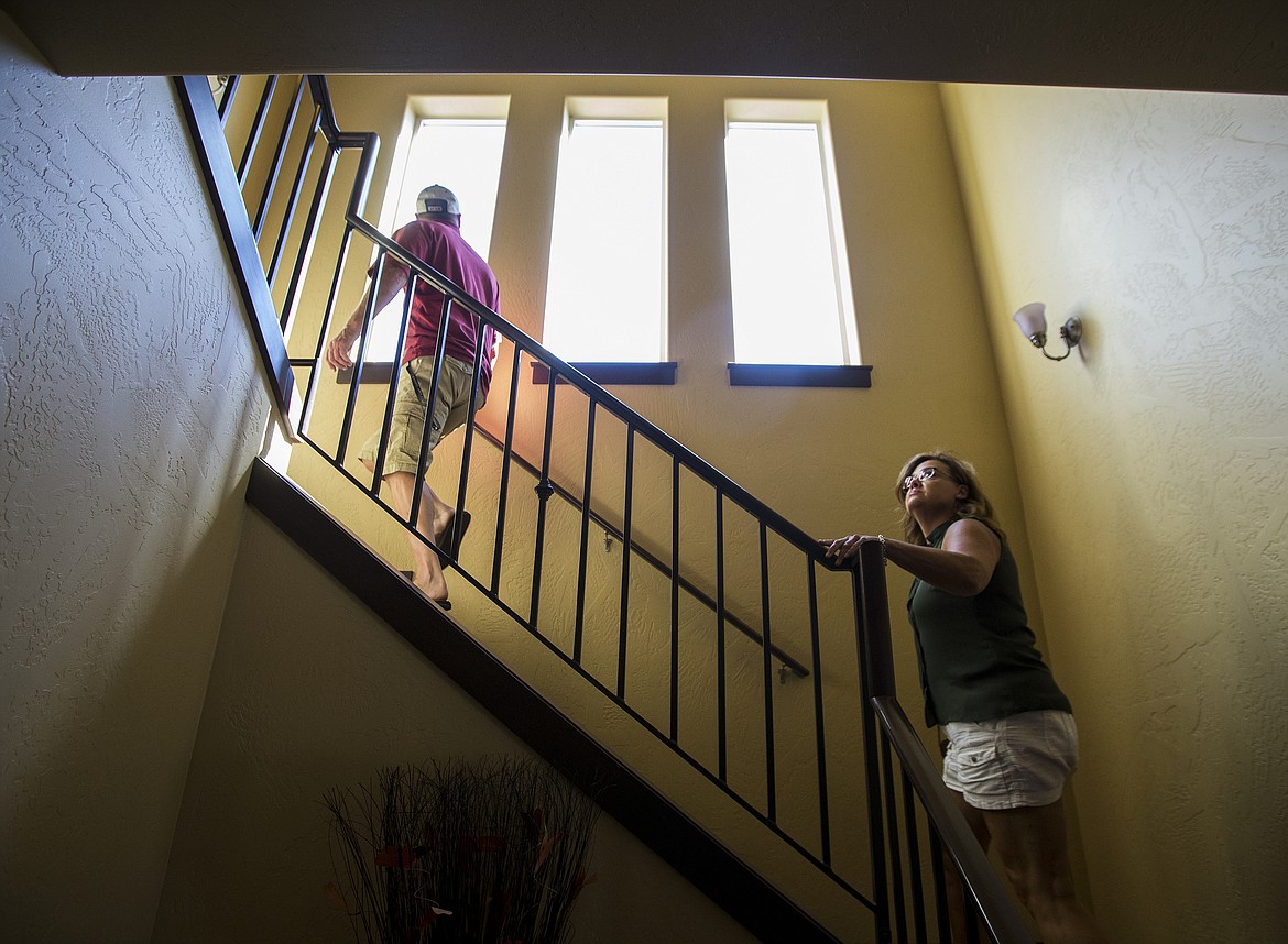 LOREN BENOIT/Press
Libbi Keyes and Glenn Barrett walk up the steps to the second floor of a home during a viewing last Thursday in Coeur d&#146;Alene.