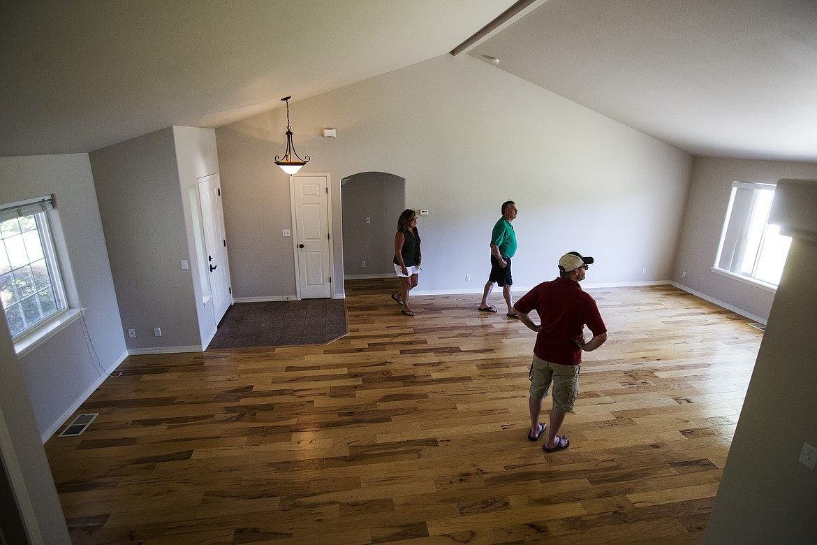 LOREN BENOIT/Press

Kim Cooper, in green, with Select Brokers LLC, shows Libbi Keyes and Glenn Barrett a house in CDA Place last Thursday. While some parts of the country are experiencing low to moderate housing prices, Coeur d&#146;Alene&#146;s market, even with rising prices, is enjoying a robust time and a lot of  in-migration.