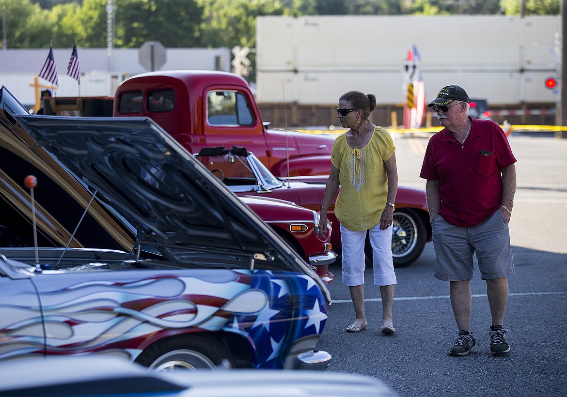 LOREN BENOIT/PressDon Lindberg and Nubi Jenson look at a 1965 Chevelle Malibu Friday evening at Rathdrum Days.