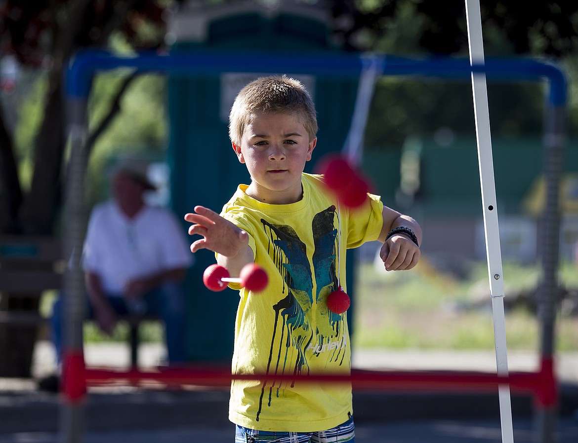 LOREN BENOIT/PressHunter Martenson plays Ladder Ball Friday evening at Rathdrum Days.