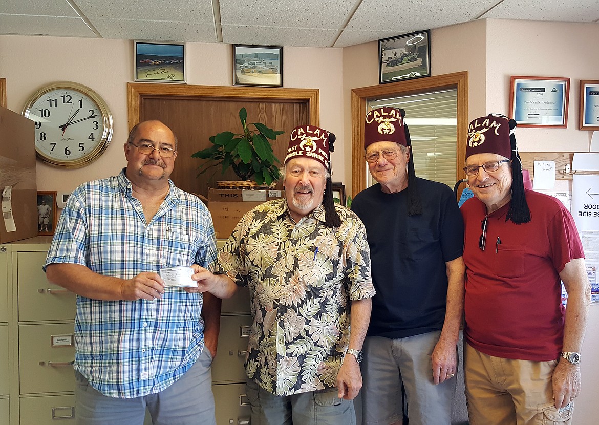 Doug Dishong of Pend Oreille Mechanical and Idaho State and Mountain States Chili Cook-off presenting check for the fundraising to Panhandle Shriners  Lee Hoge, Paul Ousley and Doug Fraser from the two-day event.

(Courtesy photo)