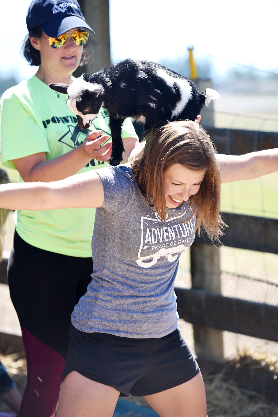 A baby goat is placed on Rachel Viano&#146;s shoulders.
