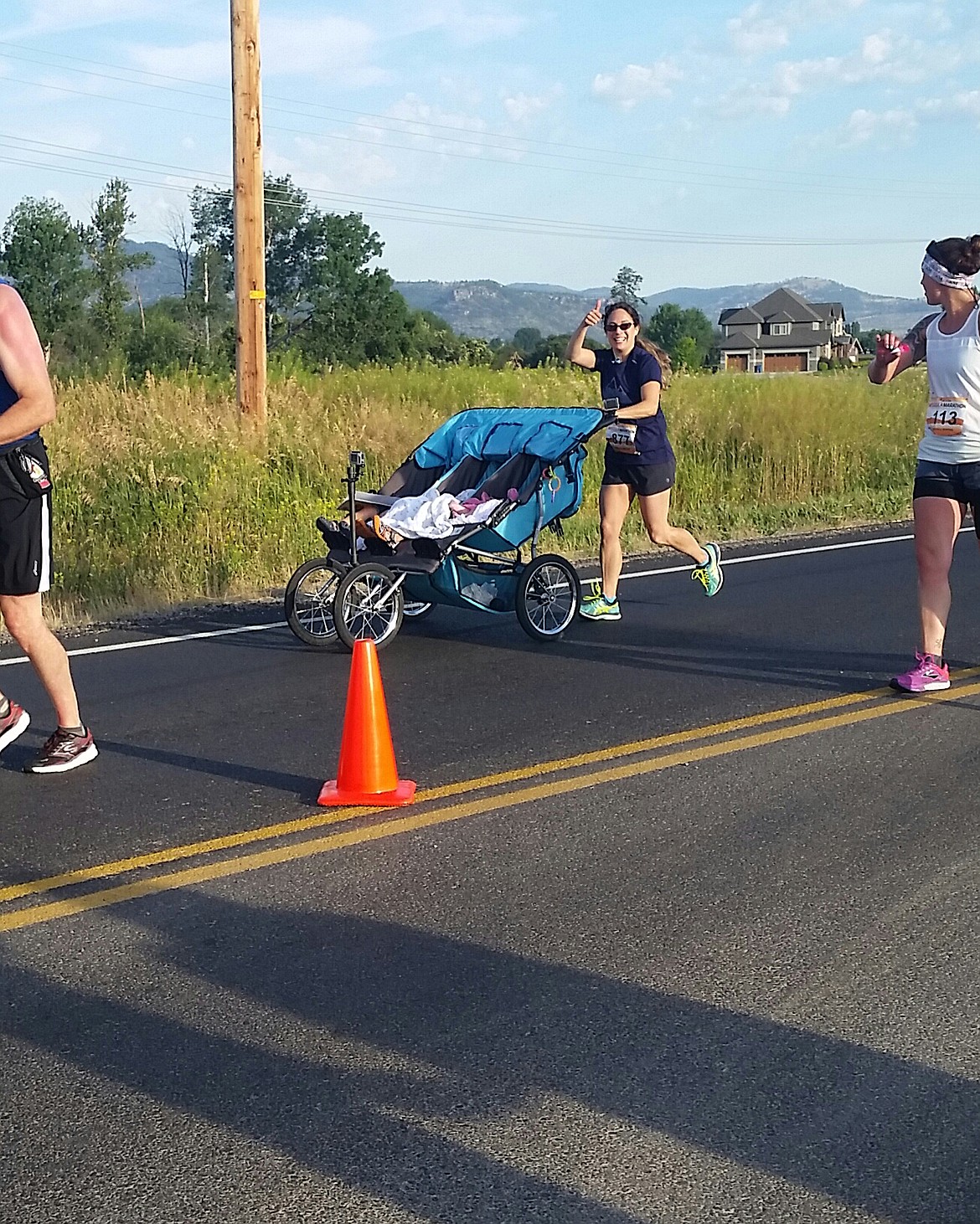 Theresa Marie Pitts of Kalispell gives a thumbs up while she pushes her children in a stroller during a marathon to set a new Guinness World Record. As part of the required documentation, Pitts outfitted the stroller with GoPro cameras to get video footage. (Photo courtesy of Theresa Marie Pitts)