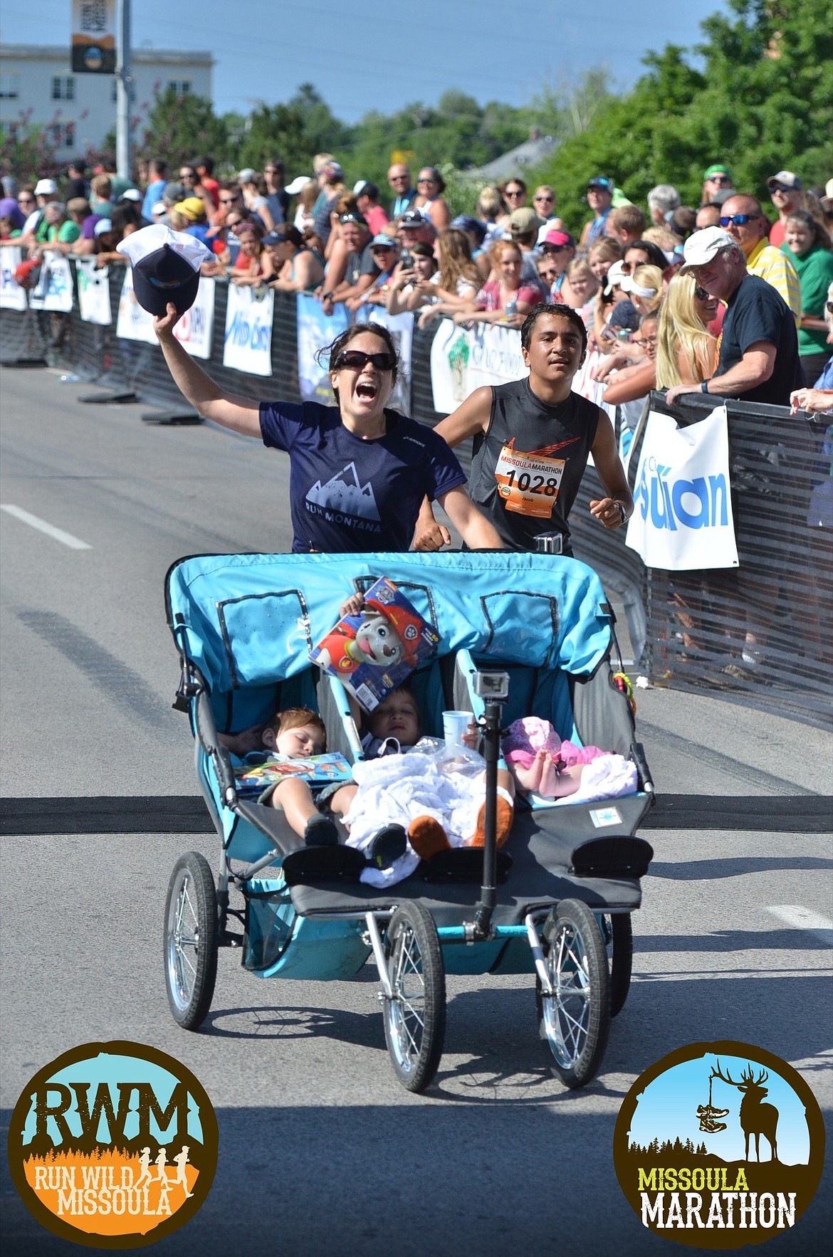 Exhausted but elated, Kalispell mother Theresa Marie Pitts makes it to the finish of the Missoula Marathon on July 9 in Missoula with her children quietly dozing in the stroller amid the excitement. (Photo by Bruce Muhlbradt)