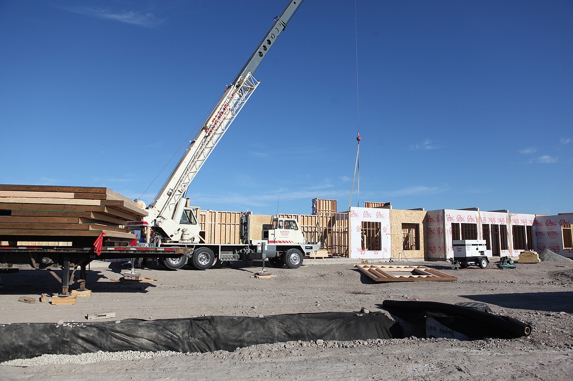 Construction on a 100-room hotel near Glacier Park International Park is in full swing. Workers put up walls Friday morning, July 14 on the 9-acre lot, which also includes space for a restaurant and convenience store. (Mackenzie Reiss/Daily Inter Lake)