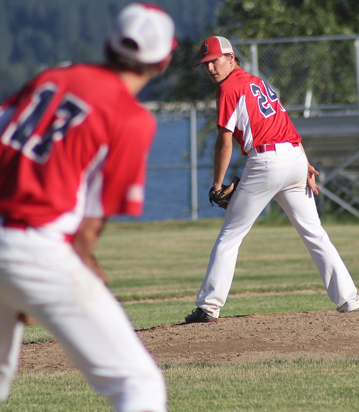 (Photo by ERIC PLUMMER)
Jacob Cometto checks on the runner in the North Idaho U19 Legion home finale on Wednesday at War Memorial Field.