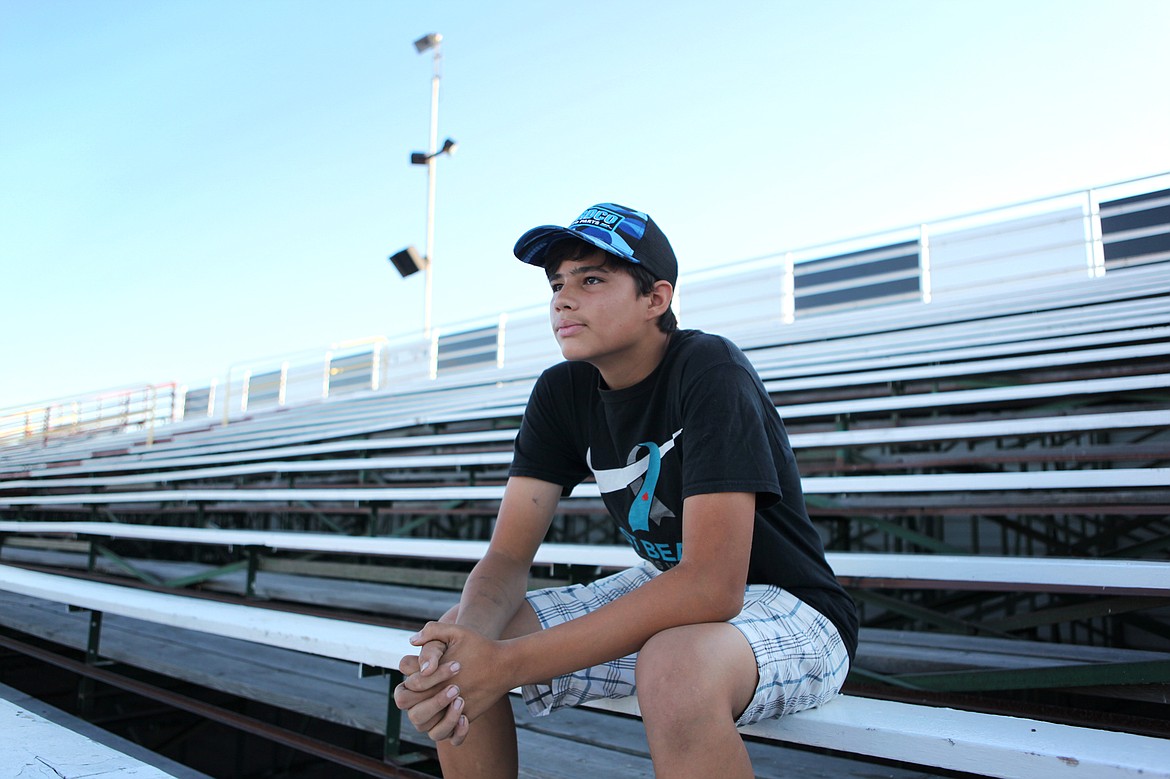 St. Ignatuis resident, Dustin Mitchell, sits in the bleachers overlooking Montana Raceway Park on July 12. The bandolero driver used to watch his father race there, but has since joined him on the track. (Mackenzie Reiss/Daily Inter Lake)