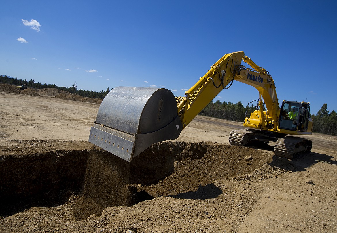 LOREN BENOIT/PressJeff Casano with Compass Construction uses an excavator to break ground Tuesday afternoon at the site of the future Super 1 Foods grocery store in Athol.