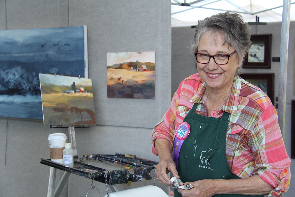 Artist Gail Hansen in her booth at a previous Arts in the Park event. (Photo courtesy of Hockaday Museum of Art)