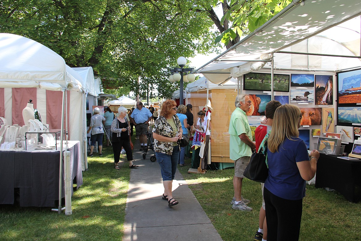Patrons browse art booths at a previous Arts in the Park event in Kalispell. (Photos courtesy of the Hockaday Museum of Art)