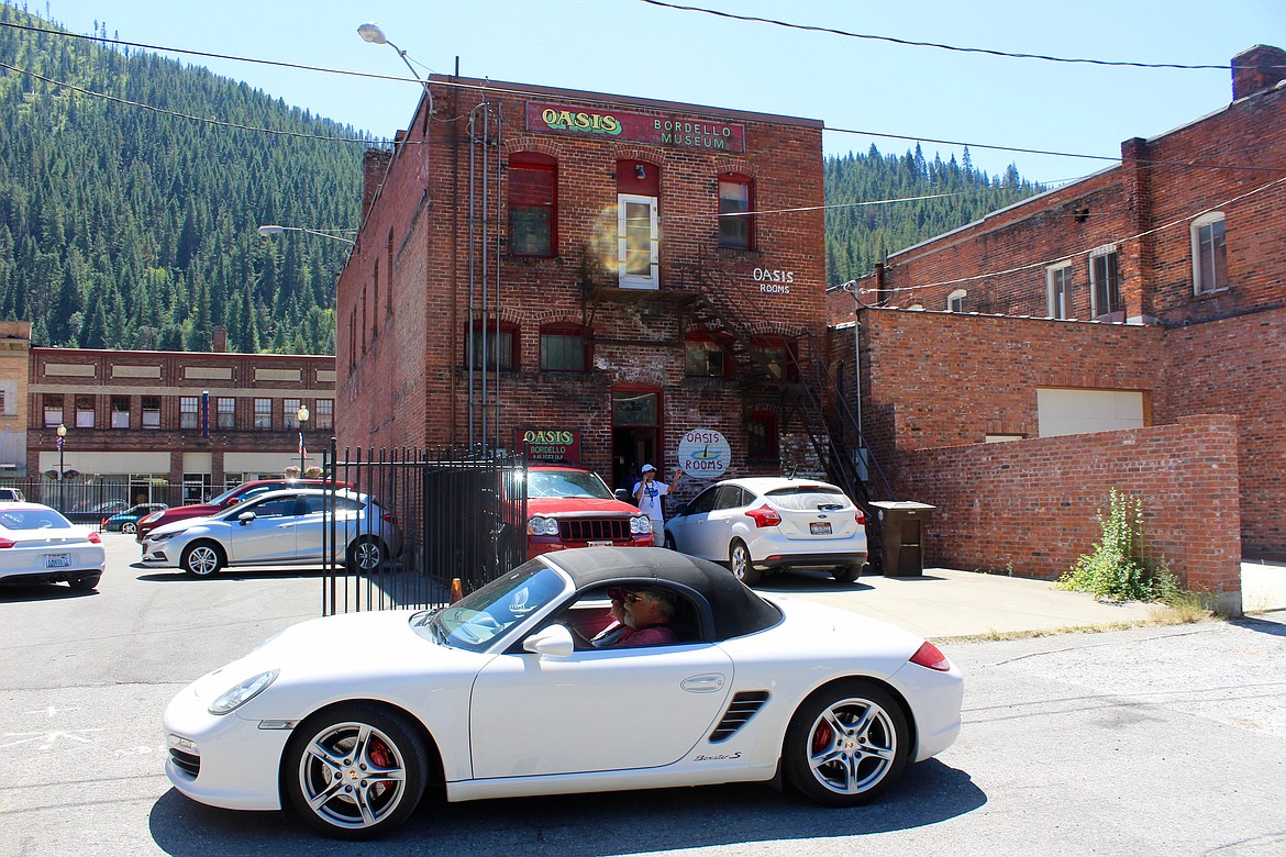 Photo by Chanse Watson. 
A porsche cruises past the rear of the Oasis. The museum was a hotspot all day for the event.