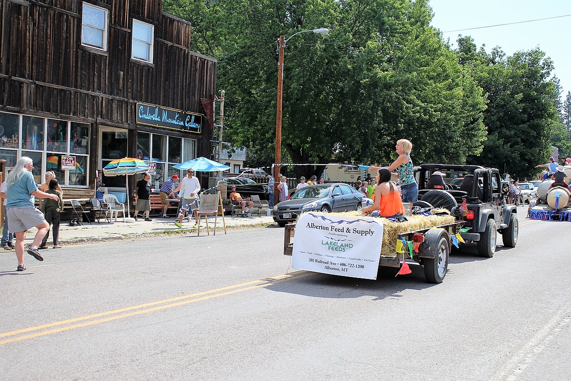 People watching the parade get a shot of cool water during the parade on Saturday in Alberton.