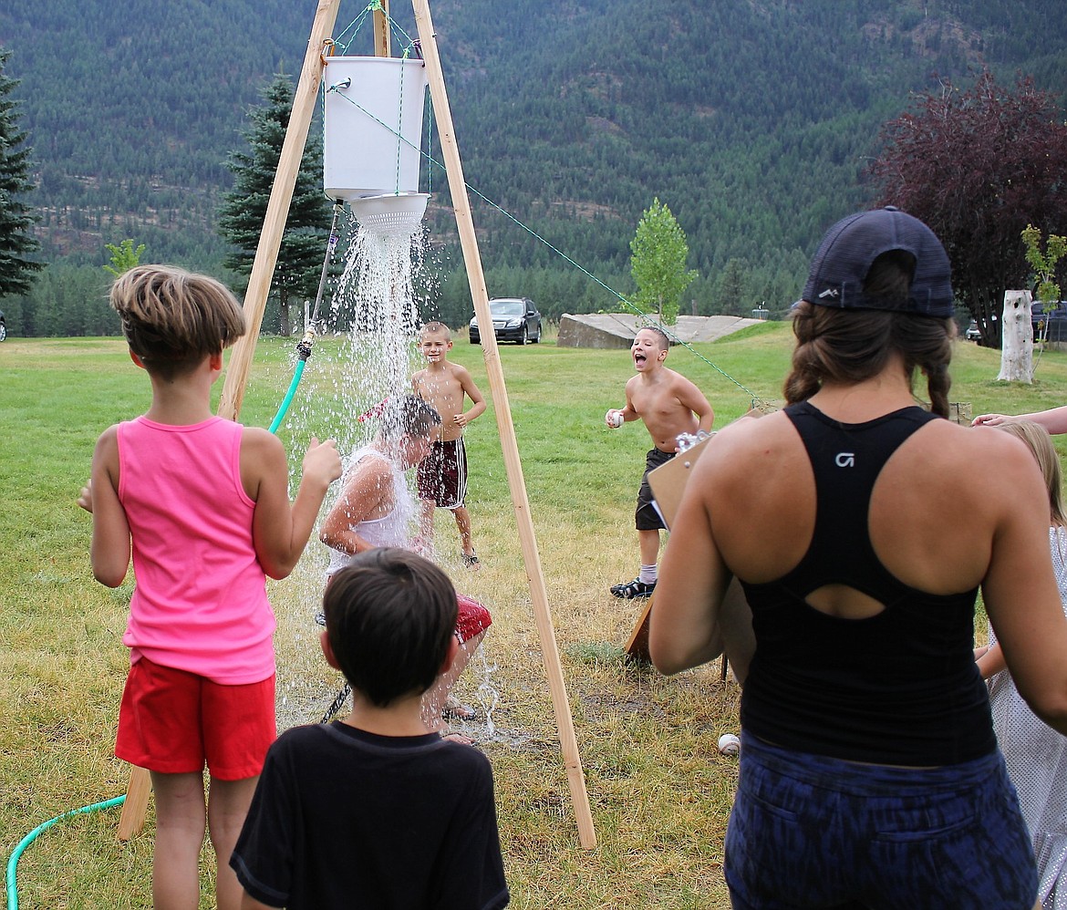 Kids stayed cool in the summer heat playing the water bucket game.