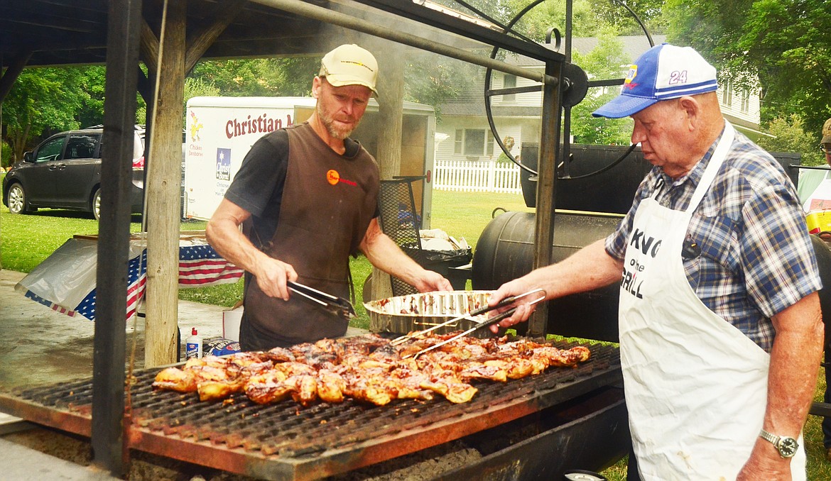 Bob Butte Don Burrell cook up the chicken Saturday (above and left). Erin Jusseaume/Clark Fork Valley Press
