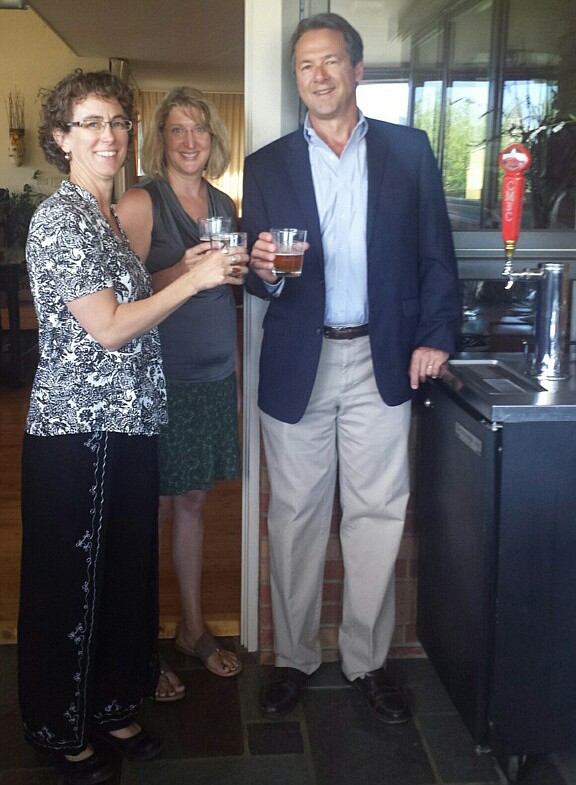 Cabinet Mountain Brewery owners Kristin Smith, left, and Sarah Sorensen, center, pose with Gov. Steve Bullock at the Governor's Mansion in Helena on July 11. The brewery, a member of the Montana Brewers Association, was selected to have a beer on tap there for a month. The brewery's Belgian-style pale ale "The Seeker" now flows from a "kegerator" -- a small refrigerator with a tap -- in the historic house. "Bullock is a huge fan of Montana breweries, and we were lucky enough to be chosen this month," Sorenson said. (Courtesy Photo)