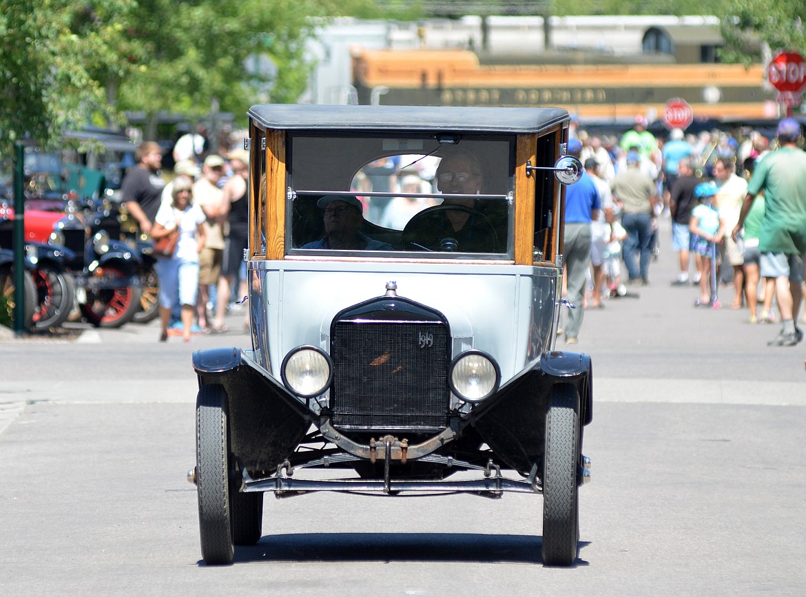 A Model T drives down Central Avenue Sunday afternoon during a Model T tour car show. Hundreds of folks came out to see the cars lining the street as part of the annual tour for the Model T Ford Club of America and the Model T Ford Club. (Heidi Desch/Whitefish Pilot)