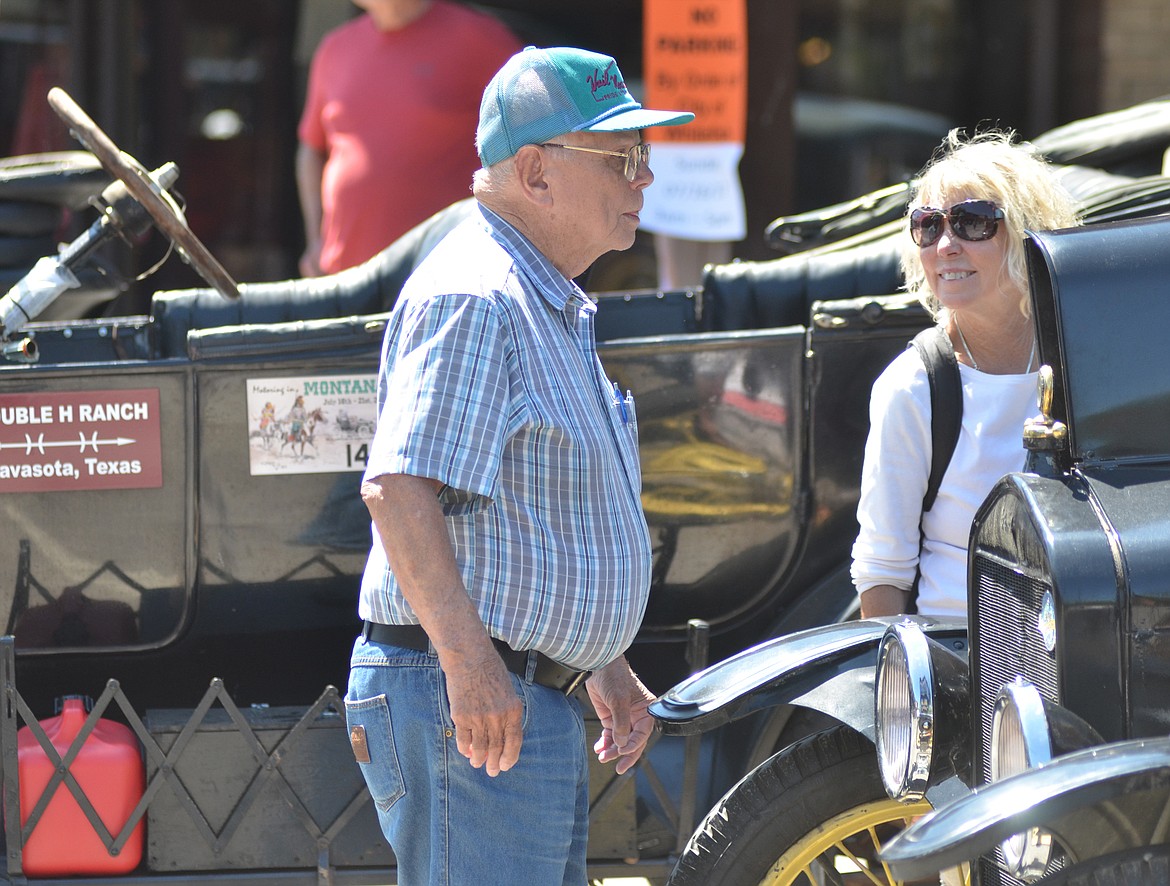 Ralph Ammondson and Barb McEvoy look at the Model T cars lining Central Avenue Sunday afternoon during the Model T car show. About 200 cars  are in the Flathead Valley for the week as part of the annual tour for the Model T Ford Club of America and the Model T Ford Club. (Heidi Desch/Whitefish Pilot)