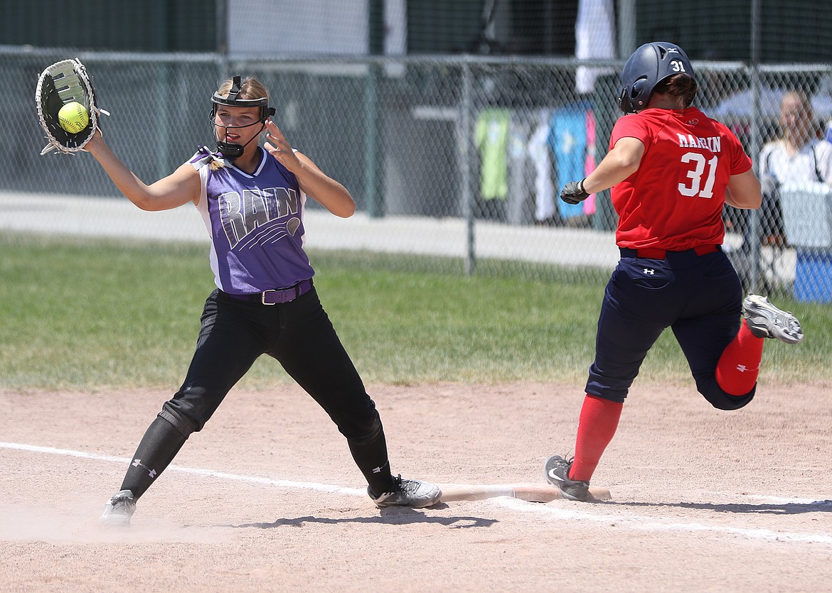 POLSON PURPLE RAIN first basemen Quinn Motichka tags a runner out during the 16,18U Team USA softball tournament Saturday in Belgrade. (photo courtesy of Bob Gunderson)