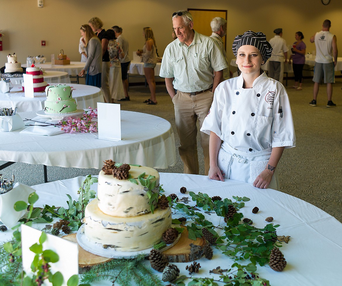 Casey Pyskaty of Hungry Horse shows off her Glacier Park-themed wedding cake. The pine cones and leaves on the cake are edible.