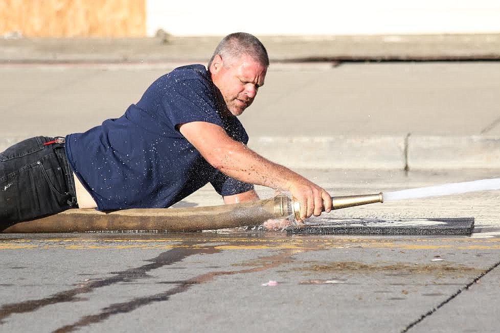 Photo by Mandi Bateman
Hall Mountain Volunteer Fire Fighter Marty Steinhagen participates in the hose race on the Fourth of July.